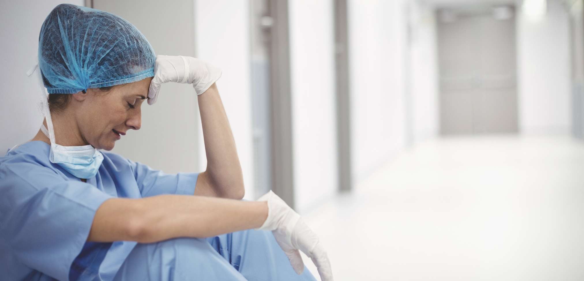 stressed nurse contemplating how to get out of nursing