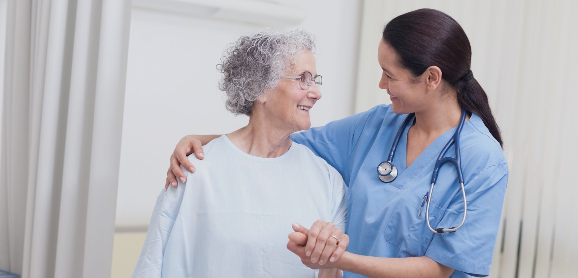 nurse and elderly patient smiling