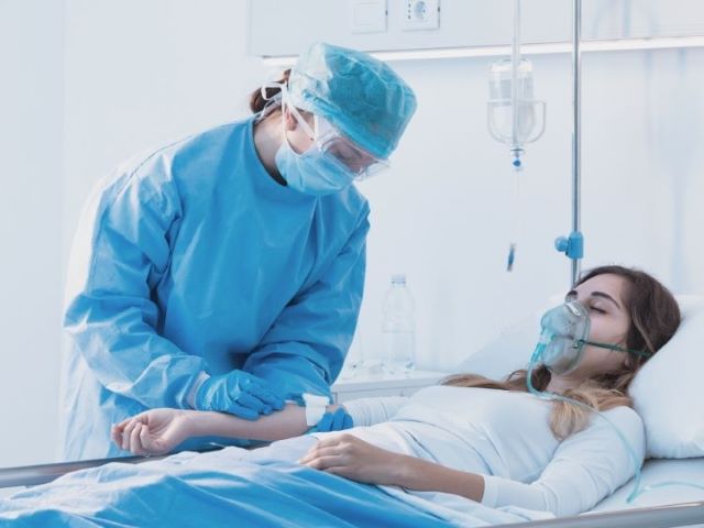 nurse checking IV on patient