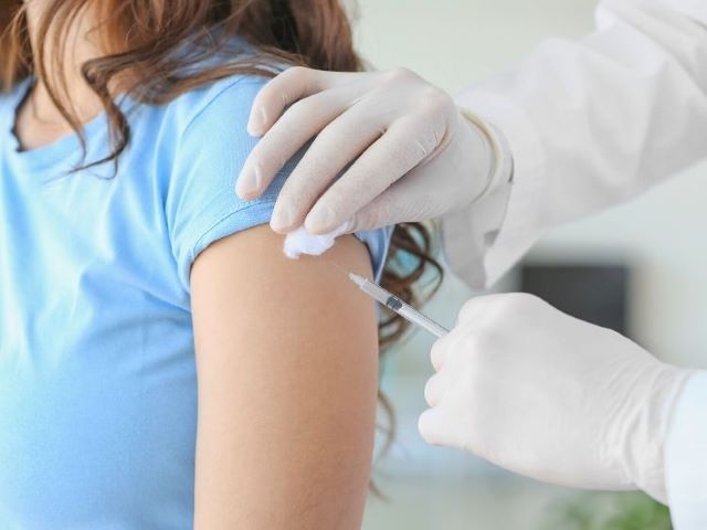 nurse giving patient covid-19 vaccine