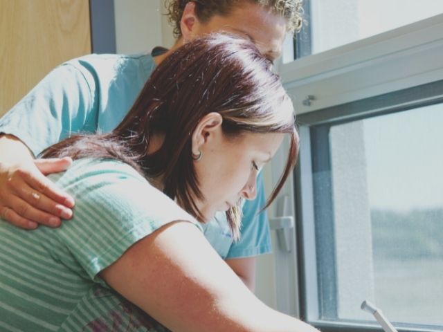 nurse helping patient in labor