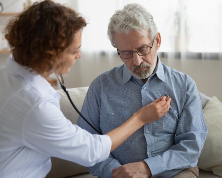 nurse checking patients heart