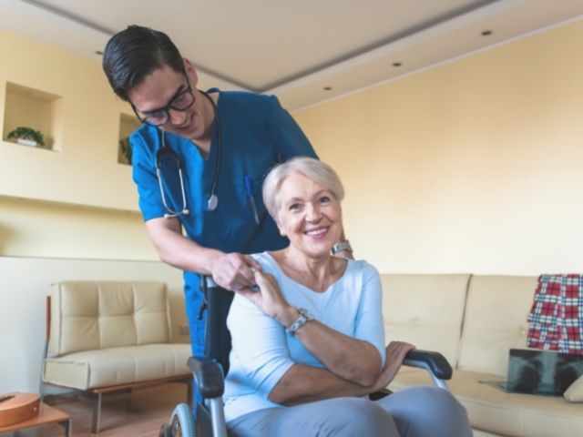 nurse helping disabled patient