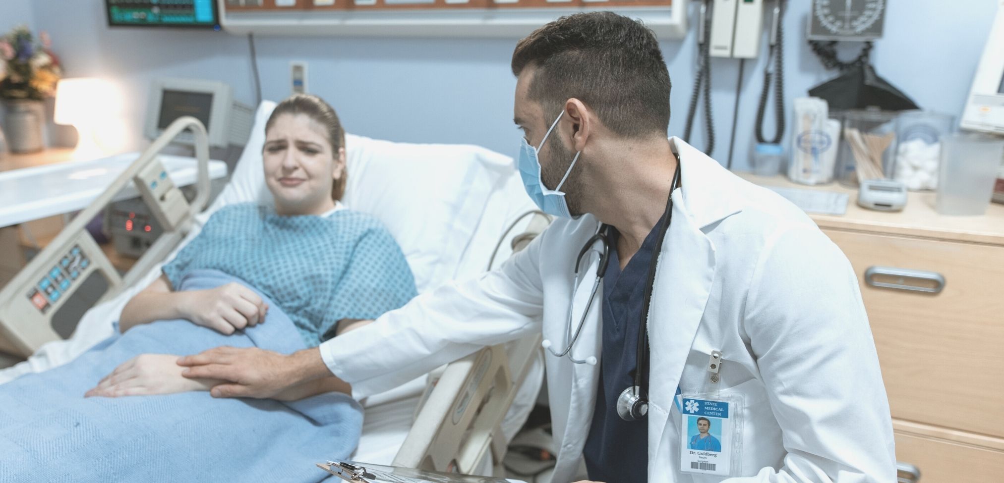 nurse comforting patient after perinatal loss